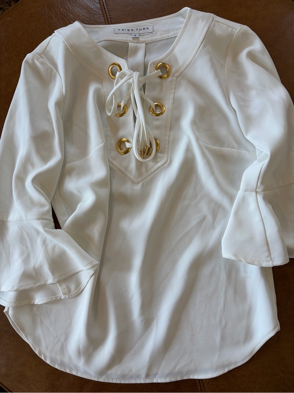 Trina Turk White Lace-Up Bell Sleeve Blouse with Gold Grommets